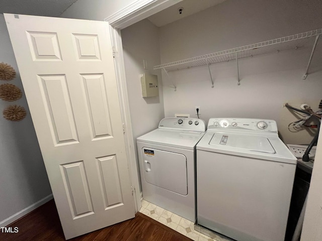 laundry area with washing machine and dryer and dark hardwood / wood-style floors