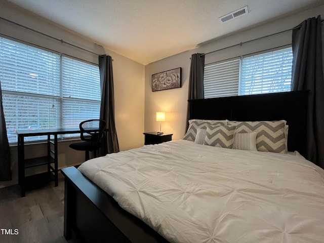 bedroom featuring a textured ceiling and carpet floors