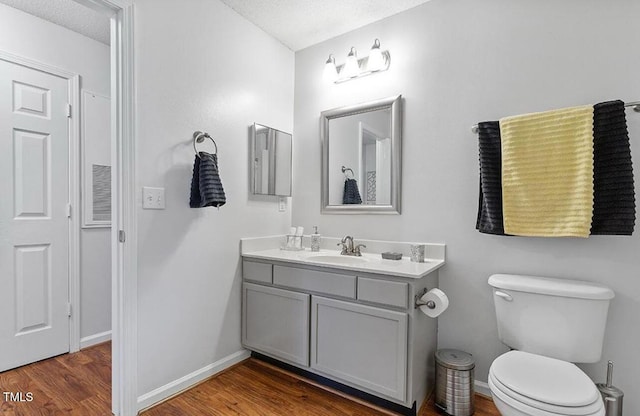 129 Sturbridge Dr Unit 15, Clayton, NC 27520 - bathroom featuring vanity, wood finished floors, toilet, and baseboards