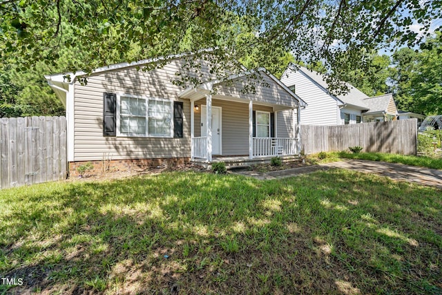 view of front of property with a front yard and covered porch