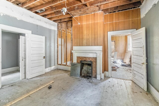 unfurnished living room with wooden walls