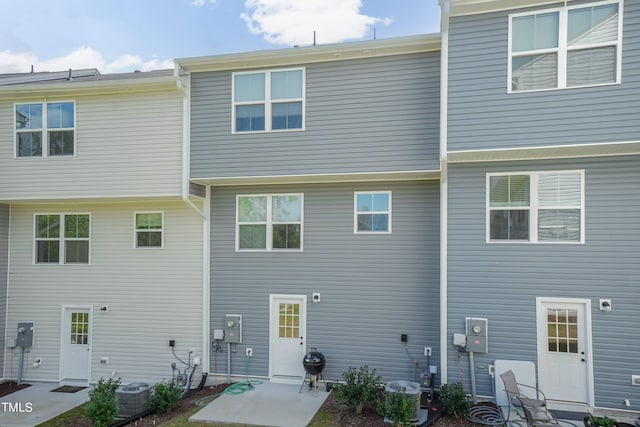 rear view of property featuring central AC and a patio