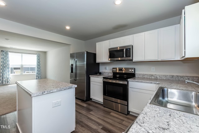 kitchen featuring white cabinetry, a kitchen island, stainless steel appliances, and dark hardwood / wood-style flooring