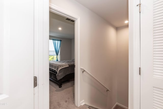 hallway featuring light colored carpet