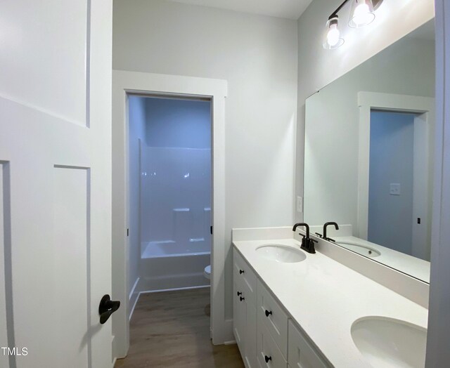 bathroom with vanity, toilet, and hardwood / wood-style floors