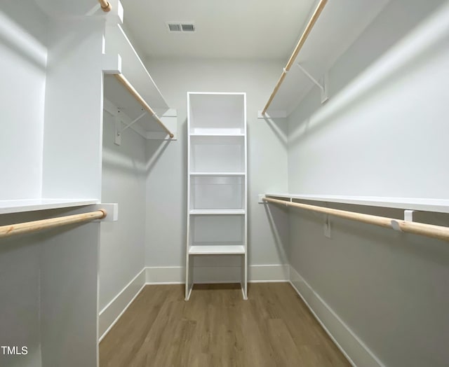 spacious closet featuring hardwood / wood-style floors