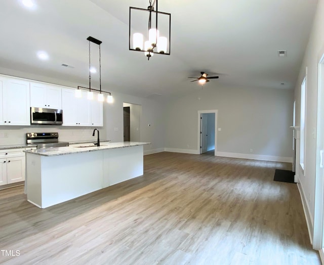 kitchen with light hardwood / wood-style flooring, ceiling fan with notable chandelier, stainless steel appliances, white cabinetry, and pendant lighting