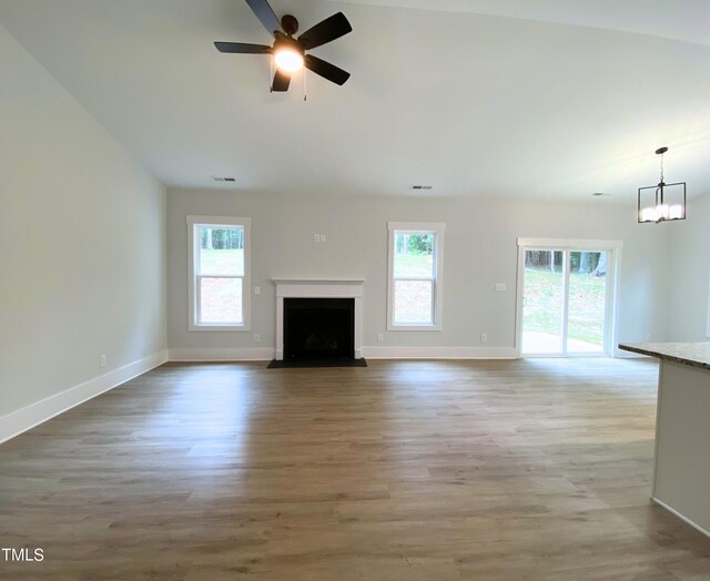 unfurnished living room featuring ceiling fan and hardwood / wood-style flooring