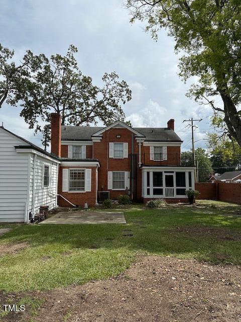 110 S Layton Ave, Dunn, NC 28334 - back of house featuring a chimney, fence, and a lawn