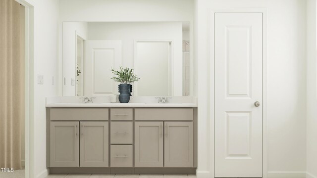 full bath featuring a sink, baseboards, and double vanity