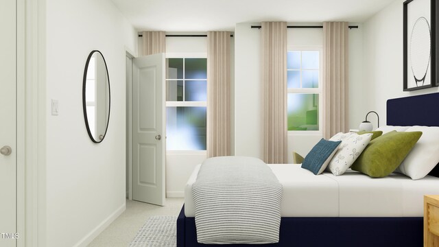 bedroom featuring baseboards and light colored carpet