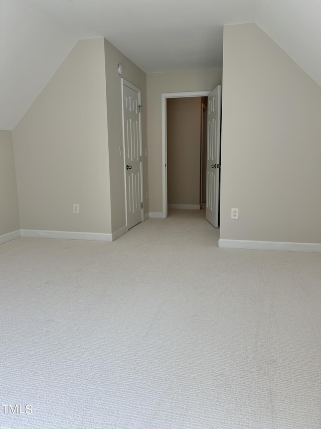 bonus room featuring light colored carpet and lofted ceiling