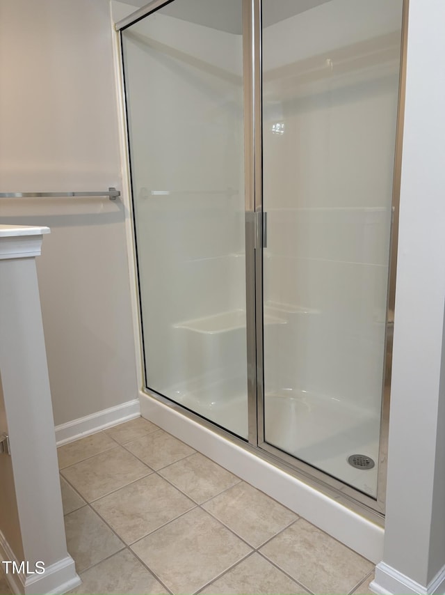 bathroom with tile patterned floors and walk in shower