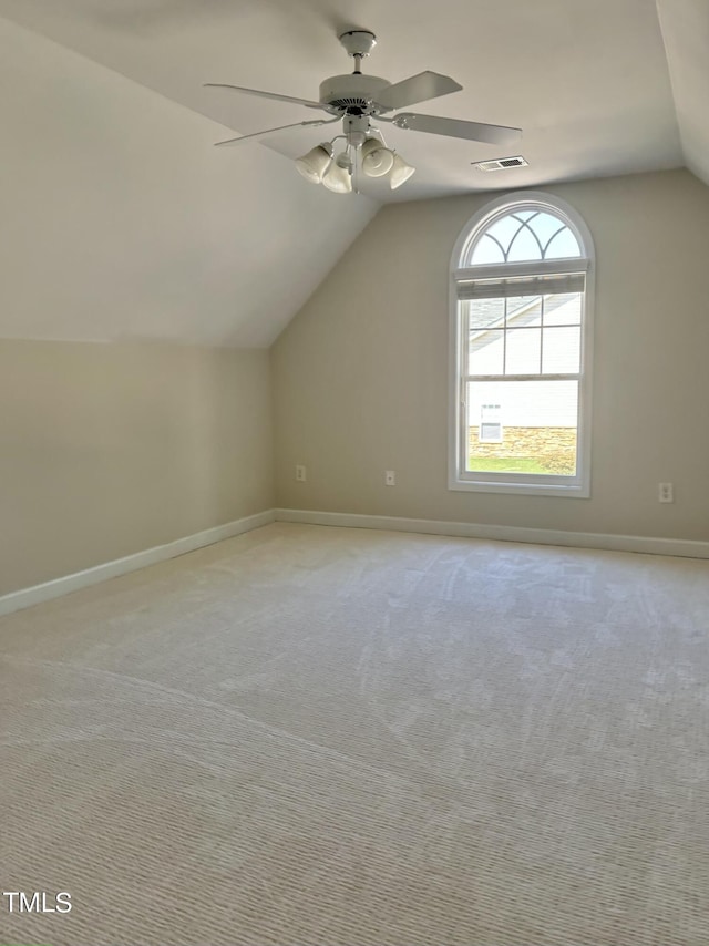 bonus room featuring ceiling fan, lofted ceiling, and light carpet