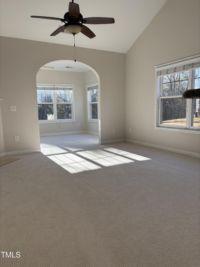 unfurnished room featuring light carpet, plenty of natural light, lofted ceiling, and ceiling fan