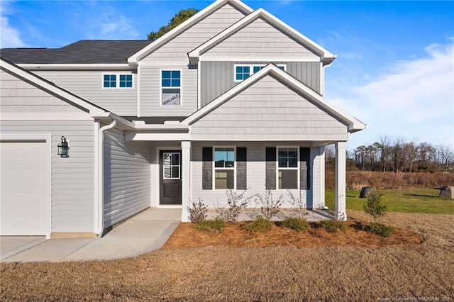 craftsman-style house with a porch and a garage