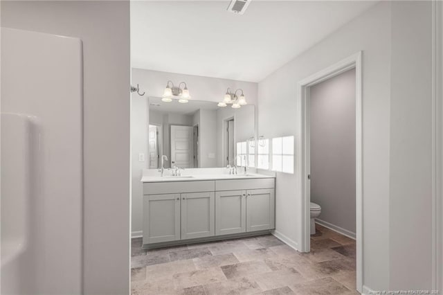 bathroom featuring vanity and toilet