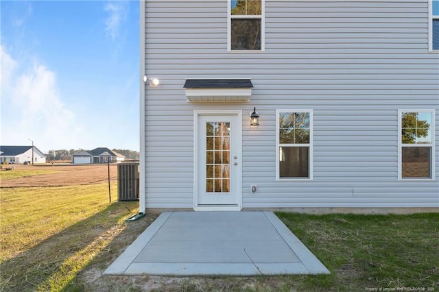 property entrance featuring a patio and a yard