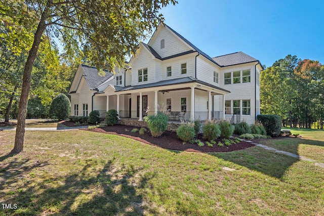 back of house with a lawn and a porch