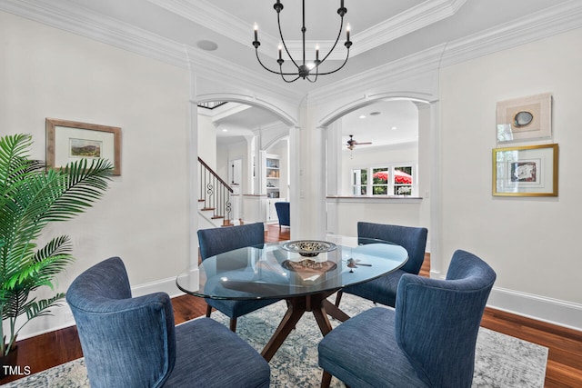 dining area featuring ornamental molding, decorative columns, wood-type flooring, and ceiling fan