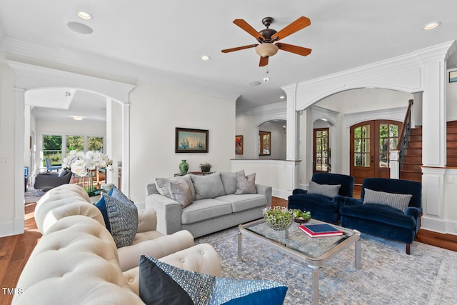 living room featuring crown molding, hardwood / wood-style flooring, and ceiling fan