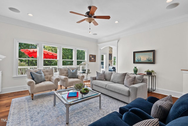 living room featuring ornamental molding, hardwood / wood-style floors, and ceiling fan