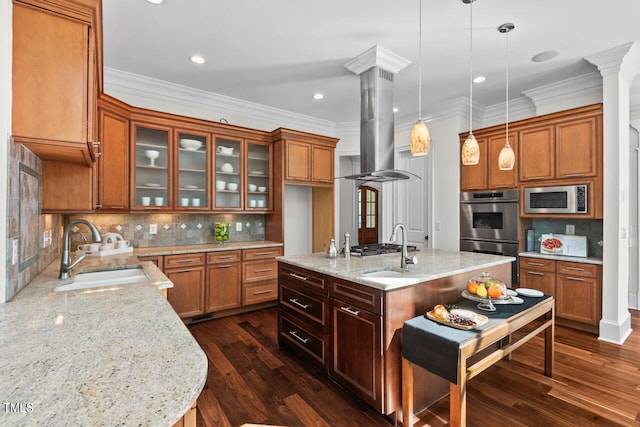 kitchen featuring appliances with stainless steel finishes, sink, island exhaust hood, hanging light fixtures, and dark wood-type flooring