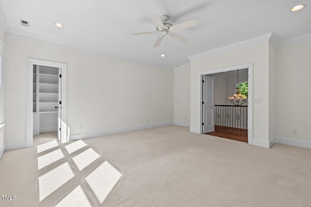 unfurnished bedroom with crown molding, ceiling fan, a walk in closet, and light colored carpet