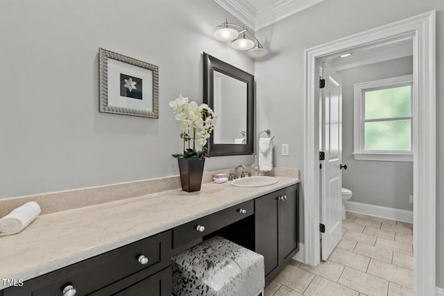 bathroom featuring vanity, toilet, and crown molding