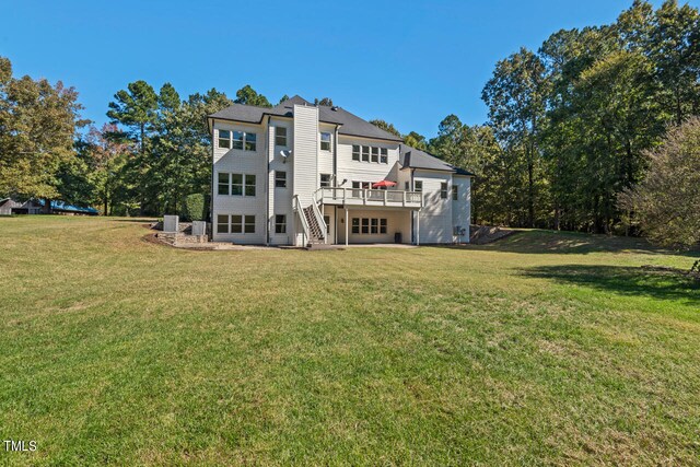 rear view of house featuring a yard