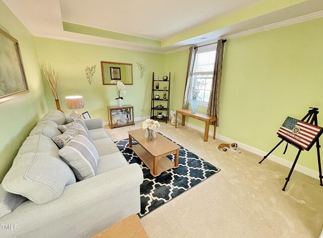 carpeted living room with crown molding and a tray ceiling