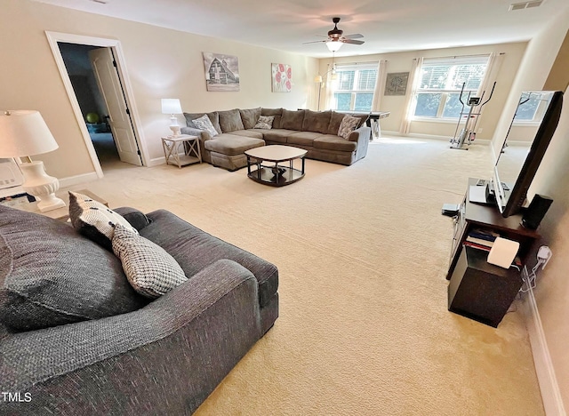 carpeted living room featuring ceiling fan