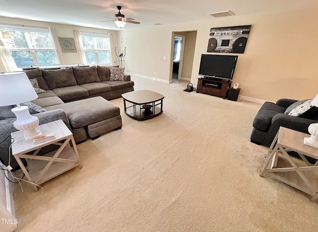 carpeted living room with ceiling fan