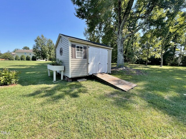 view of outdoor structure with a lawn