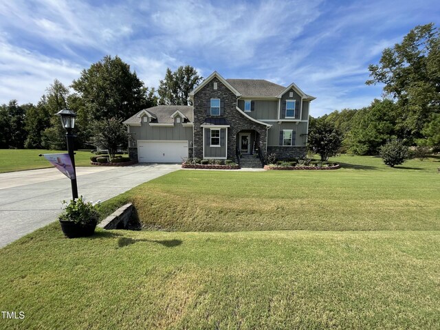 craftsman inspired home with a front yard and a garage