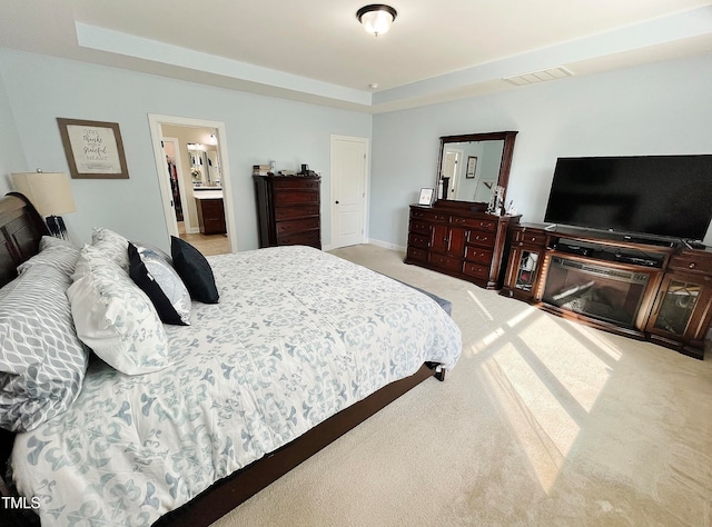 carpeted bedroom featuring ensuite bathroom