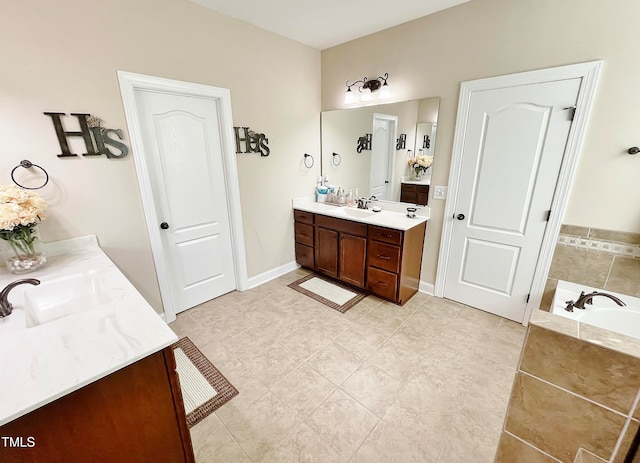 bathroom featuring vanity, a relaxing tiled tub, and tile patterned flooring