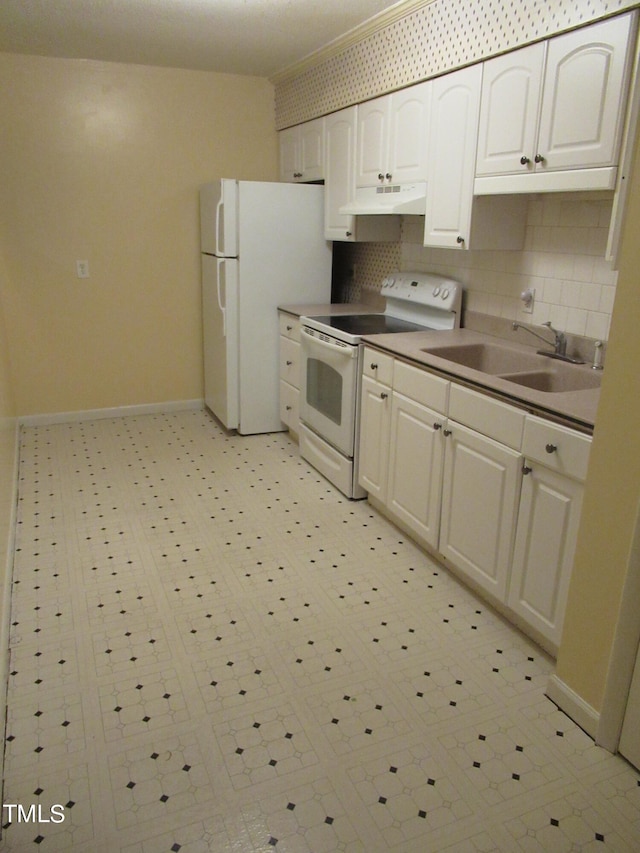 kitchen with sink, white appliances, white cabinetry, and backsplash