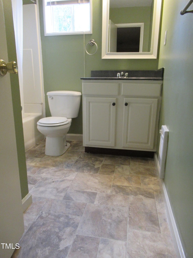 full bathroom with vanity, toilet, and washtub / shower combination