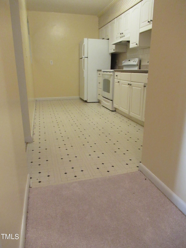 kitchen featuring white cabinets, light colored carpet, tasteful backsplash, and white appliances