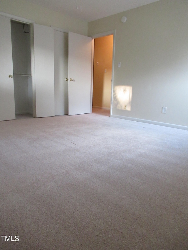 unfurnished bedroom featuring light colored carpet