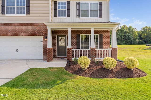 view of front of house featuring a garage, a front lawn, and covered porch