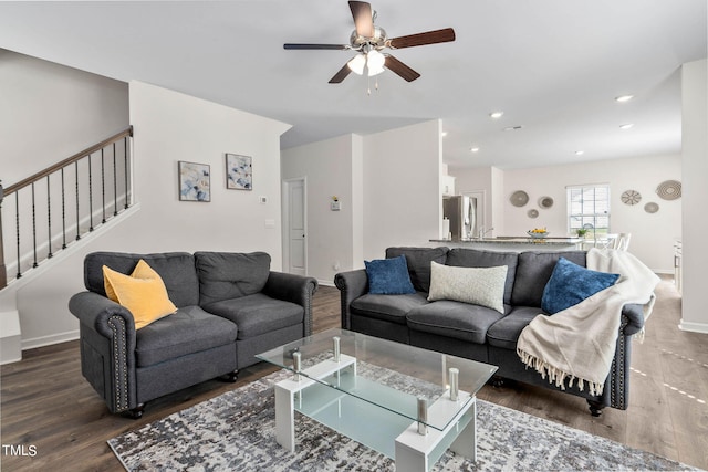 living room with dark hardwood / wood-style flooring and ceiling fan