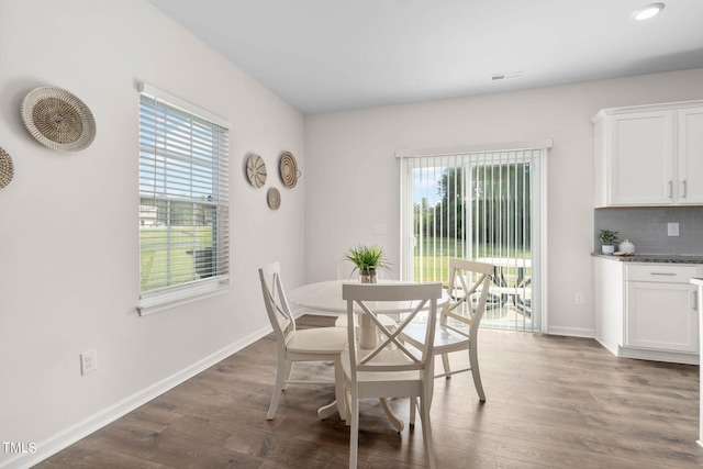 dining room with dark hardwood / wood-style floors