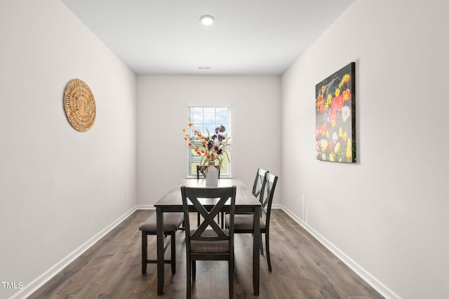 dining area with dark hardwood / wood-style floors