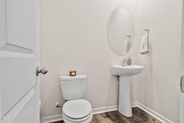 bathroom featuring toilet and hardwood / wood-style floors