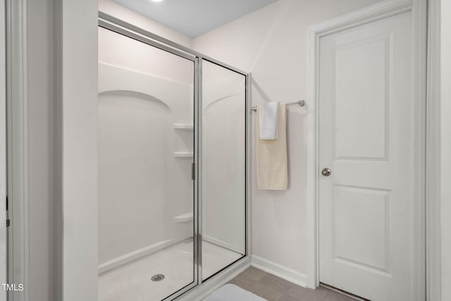 bathroom with a shower with shower door