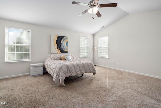 carpeted bedroom with ceiling fan and vaulted ceiling