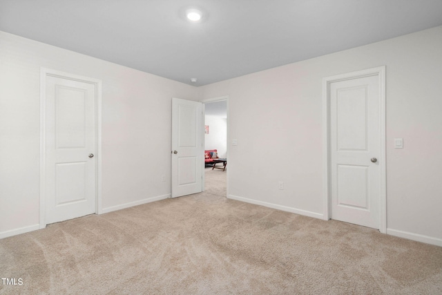 unfurnished bedroom featuring light carpet