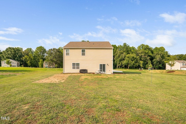 rear view of property with a lawn